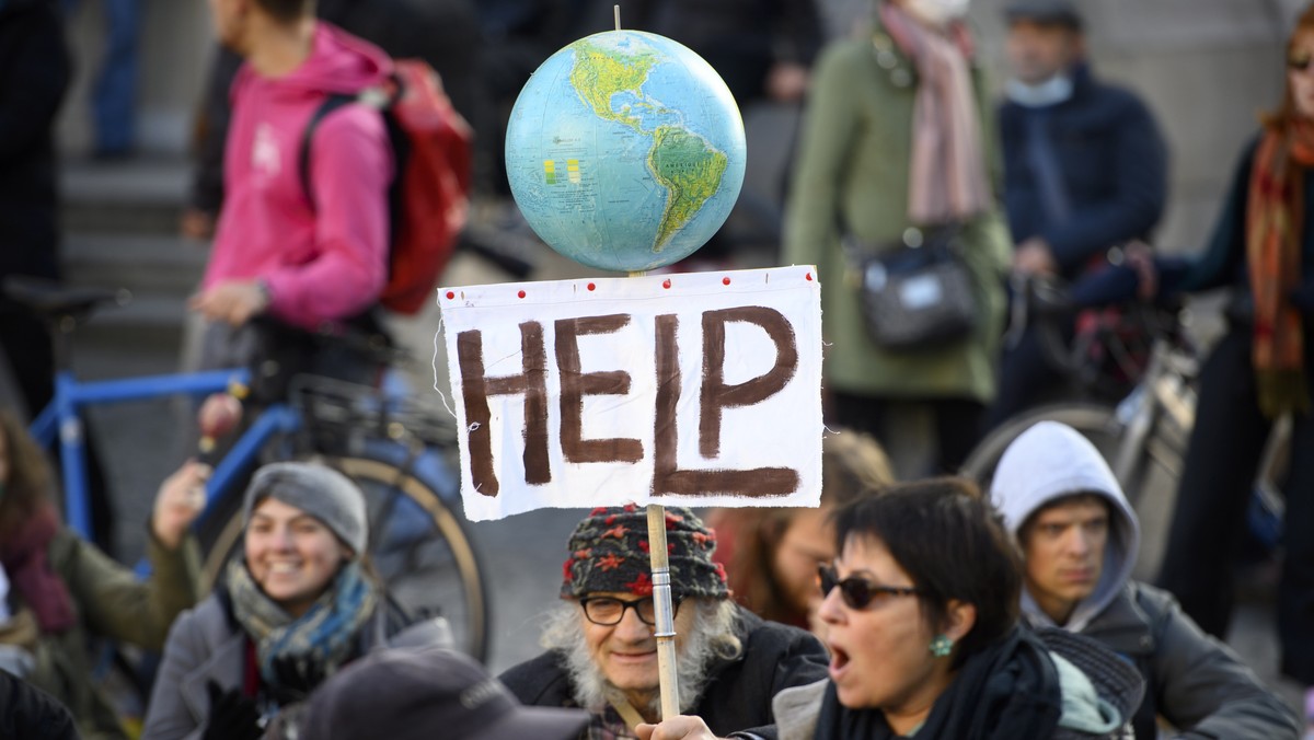 epa09567977 People take part in demonstration '26 years of COP: only words in the air! for a popular ecology!' to demand actions from world leaders against climate change, in Lausanne, Switz ...