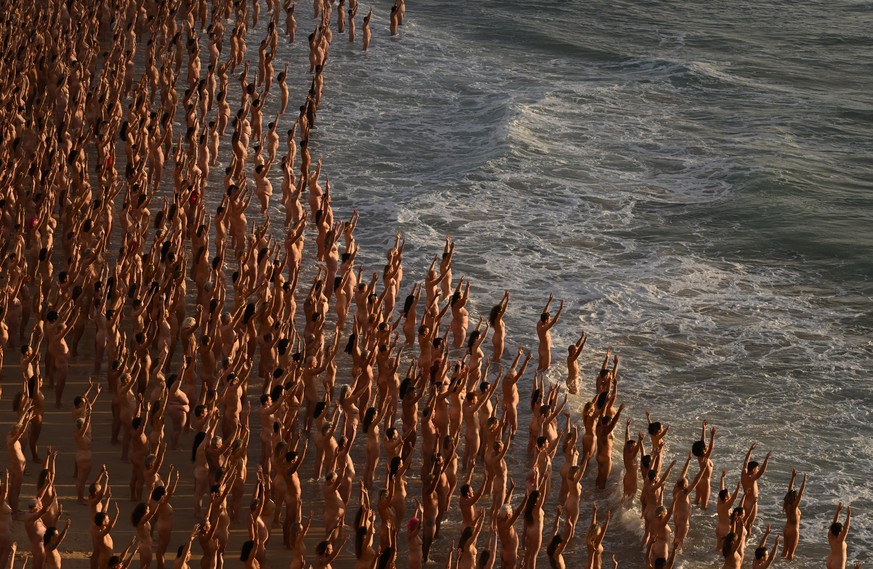epa10328820 Thousands of people stand nude, as part of an installation by contemporary artist Spencer Tunick, at Bondi Beach in Sydney, Australia 26 November 2022. Thousands of people have bared all f ...