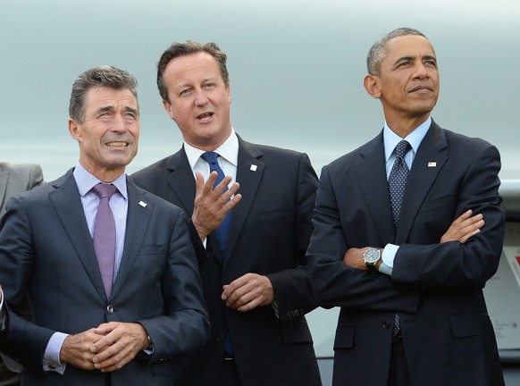 epa04385318 (L-R) NATO Secretary General Anders Fogh Rasmussen, British Prime Minister David Cameron and US President Barack Obama watch a military fly past during the NATO Summit 2014 at the Celtic M ...