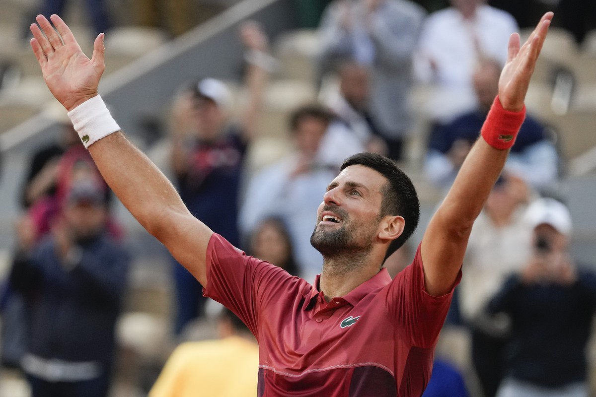 Serbia's Novak Djokovic celebrates winning his fourth round match of the French Open tennis tournament against Argentina's Francisco Cerundolo at the Roland Garros stadium in Paris, Monday,  ...