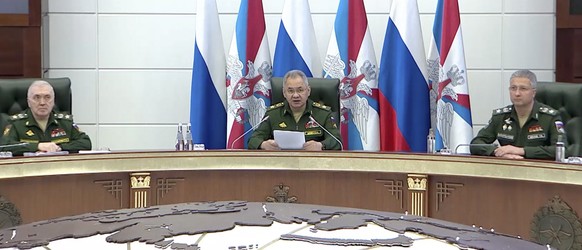 epa10702474 A handout photo made available by the press service of the Russian Defense Ministry shows Russian Army Defense Minister Sergei Shoigu (C) delivering his speech at a meeting of the…