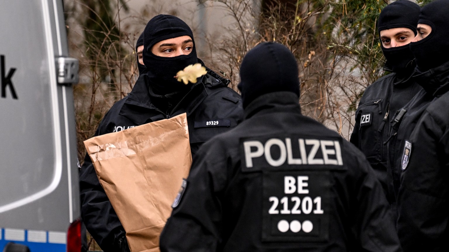 epa10353399 Police officers work during a raid in Berlin, Germany, 07 December 2022. Twenty-five people allegedly affiliated to the so-called Reichs Citizens (Reichsbuerger) movement were arrested in  ...