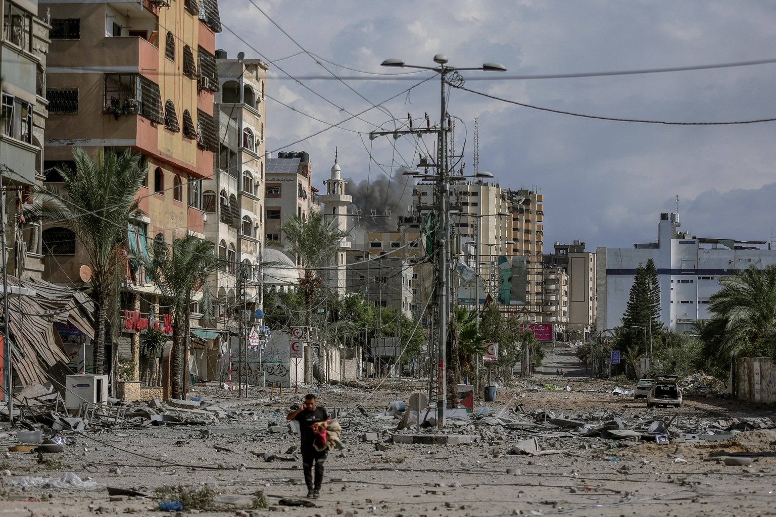 Humanitarian Catastrophe Looms After Israeli Attacks - Gaza People walking amidst the destruction of houses and streets in Khan Yunis, located in the southern Gaza Strip, amid the devastation caused b ...