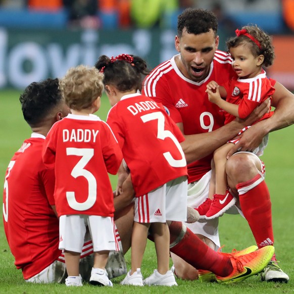 epa05402468 Hal Robson-Kanu (R) and Neil Taylor (L) of Wales celebrate on the pitch with their children after the UEFA EURO 2016 quarter final match between Wales and Belgium at Stade Pierre Mauroy in ...