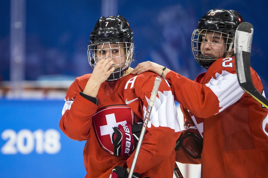 Lara Stalder of Switzerland, and Alina Muller of Switzerland, from left, react after the women ice hockey quarter final match between the team of Olympic Athletes of Russia (OAR) and Switzerland in th ...