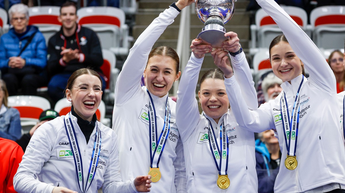 From left to right, Switzerland skip Xenia Schwaller, third Selina Gafner, vice-skip Fabienne Rieder and lead Selina Rychiger raise the trophy after defeating Canada to win the World Women's Curl ...