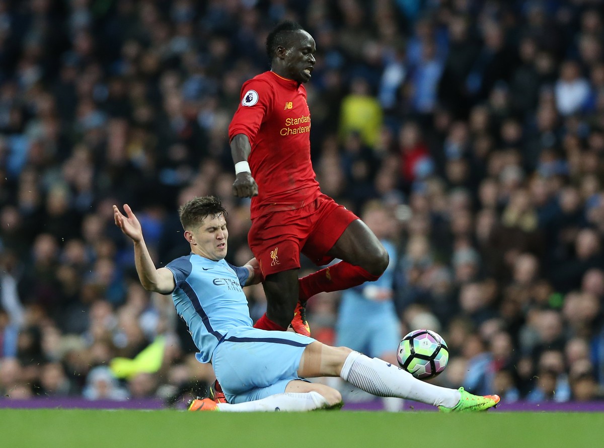 epa05858624 Manchester City's John Stones (L) challenges Liverpool's Sadio Mane during the English Premier League soccer match between Manchester City and Liverpooll at the Etihad Stadium, M ...