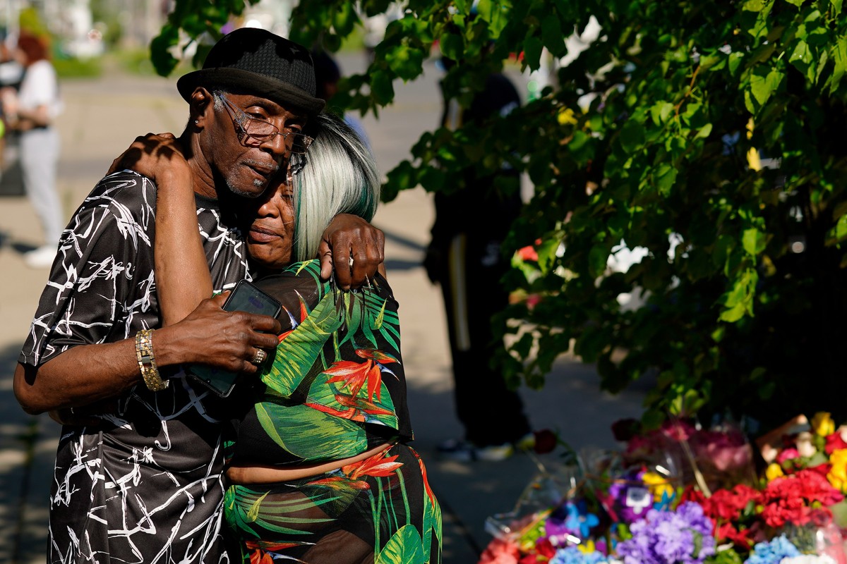People embrace outside the scene of a shooting at a supermarket a day earlier, in Buffalo, N.Y., Sunday, May 15, 2022. The shooting is the latest example of something that's been part of U.S. his ...