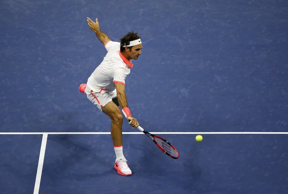 Roger Federer, of Switzerland, returns a shot to Stan Wawrinka, of Switzerland, during a semifinal match at the U.S. Open tennis tournament, Friday, Sept. 11, 2015, in New York. (AP Photo/Julio Cortez ...