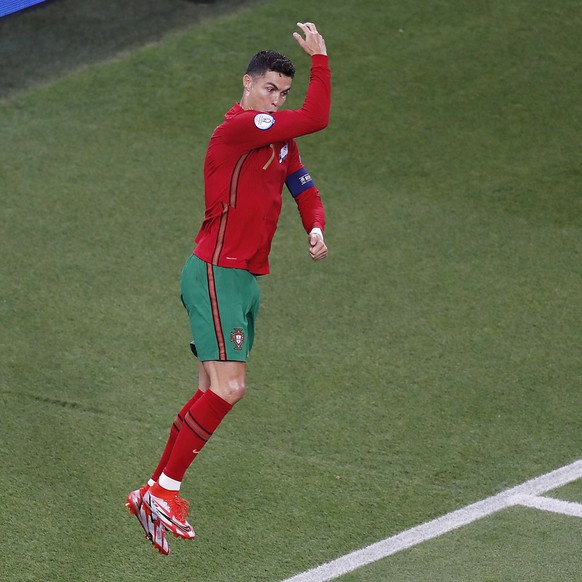 epa09297571 Cristiano Ronaldo of Portugal celebrates after scoring his team&#039;s first goal during the UEFA EURO 2020 group F preliminary round soccer match between Portugal and France in Budapest,  ...