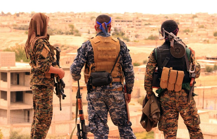 FILE -- This April 30, 2017, file photo, provided by the Syrian Democratic Forces (SDF), shows fighters from the SDF looking toward the northern town of Tabqa, Syria. U.S.-backed Syrian forces have la ...