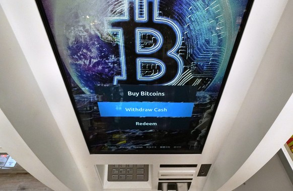 FILE - In this Feb. 9, 2021 file photo, the Bitcoin logo appears on the display screen of a crypto currency ATM at the Smoker&#039;s Choice store in Salem, N.H. The price of Bitcoin fell as much as 29 ...