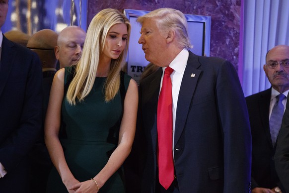 President-elect Donald Trump talks to his daughter prior to his news conference in the lobby of Trump Tower in New York, Wednesday, Jan. 11, 2017. (AP Photo/Evan Vucci)