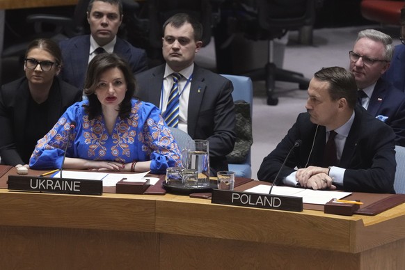 Mariana Betsa, Deputy Foreign Minister of Ukraine, left, addresses the UN Security Council, as Poland Foreign Minister Radoslaw Sikorski, right, listens Monday, Feb. 24, 2025, at the United Nations he ...