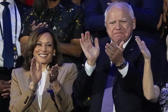 Democratic presidential nominee Vice President Kamala Harris and Democratic vice presidential nominee Minnesota Gov. Tim Walz applaud during the Democratic National Convention Monday, Aug. 19, 2024, i ...
