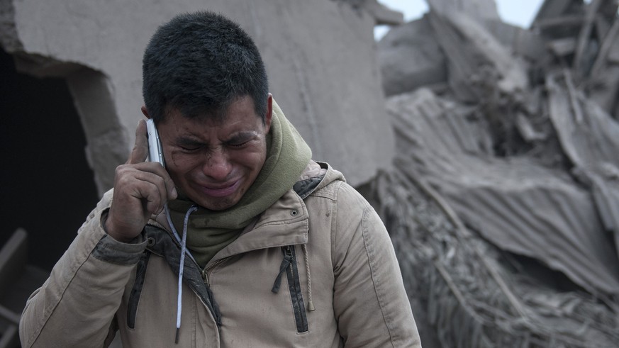 Boris Rodriguez, 24, who is searching for his wife, cries after seeing the condition of his neighborhood, destroyed by the erupting Volcan de Fuego, or &quot;Volcano of Fire,&quot; in Escuintla, Guate ...