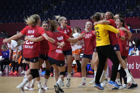 Norway team players react as they won the women&#039;s preliminary round group A handball match between Norway and the Netherlands at the 2020 Summer Olympics, Saturday, July 31, 2021, in Tokyo, Japan ...