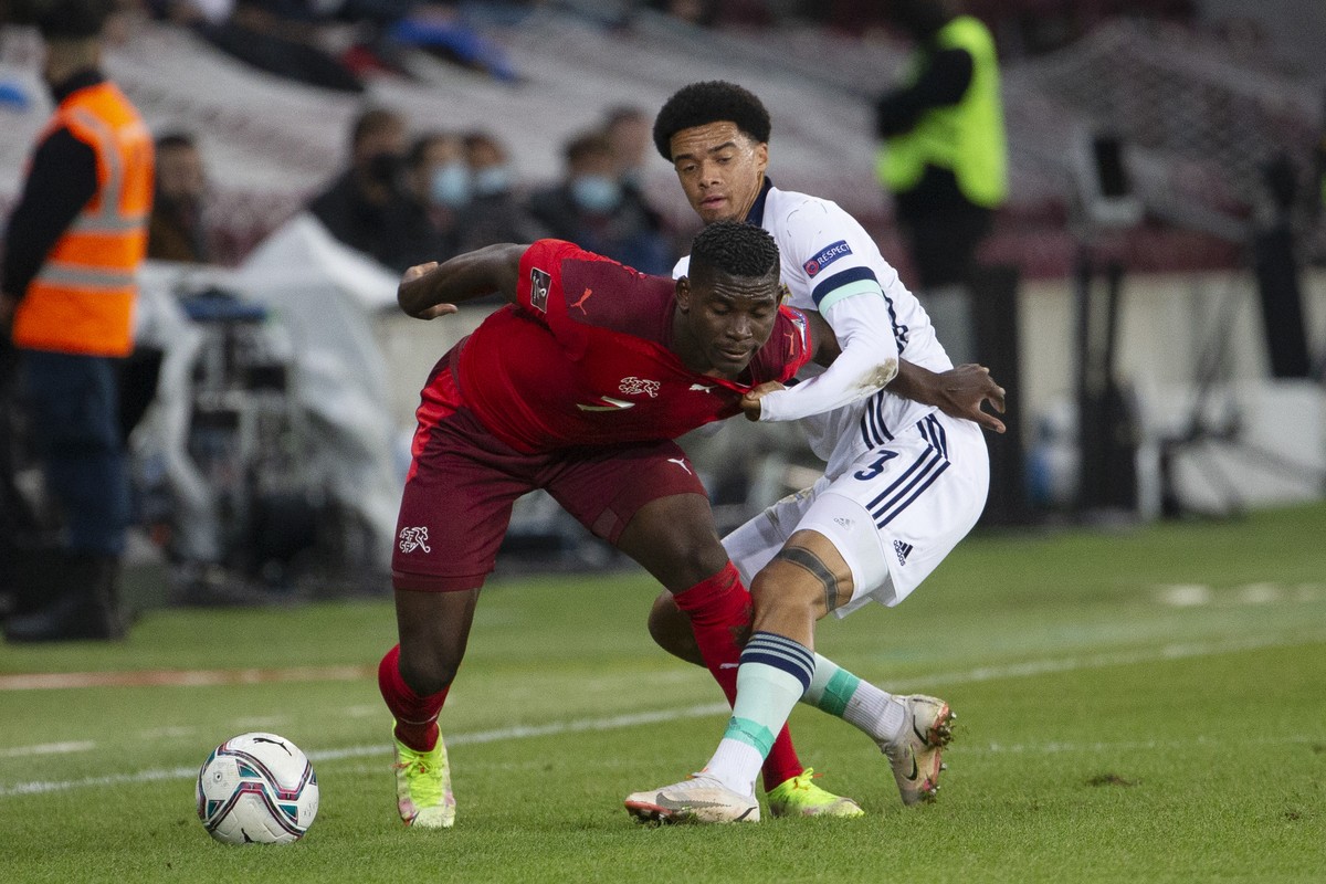 Switzerland's forward Breel Embolo, left, fights for the ball against Northern Ireland's defender Jamal Lewis, right, during the 2022 FIFA World Cup European Qualifying Group C football matc ...