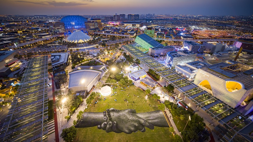 epa09551775 An aerial view taken with a drone shows a giant landart fresco by French-Swiss artist Saype, painted for the 11th step of his worldwide &#039;Beyond Walls&#039; project, at the Expo 2020 W ...