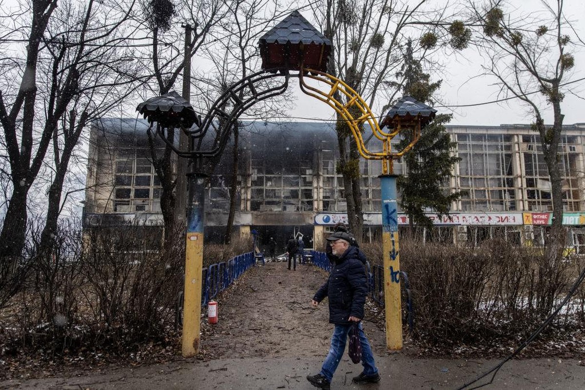 KYIV, UKRAINE - MARCH 02: A man walks past the entrance of a damaged sports complex building across the street from the Kyiv TV Tower on March 02, 2022 in Kyiv, Ukraine. The country's president, ...