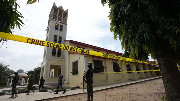 Nigerian police stand guard outside of the St. Francis Catholic church in Owo, Nigeria, Monday, June 6, 2022 a day after an attack that targeted worshipers. The gunmen who killed 50 people at a Cathol ...