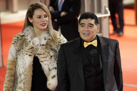 Argentinian soccer legend Diego Maradona and his girlfriend Rocio Oliva arrive for the 2018 soccer World Cup draw in the Kremlin in Moscow, Friday, Dec. 1, 2017. (AP Photo/Dmitri Lovetsky)