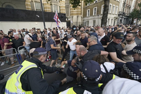 Police officers clash with protesters during a &#039;Enough is Enough&#039; protest rally in Whitehall, London, Wednesday July 31, 2024 following the fatal stabbing of three children at a Taylor Swift ...