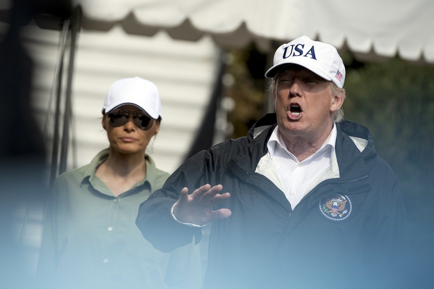 President Donald Trump, accompanied by first lady Melania Trump, speaks to the media on the South Lawn of the White House in Washington, Thursday, Sept. 14, 2017, after meeting with citizens impacted  ...