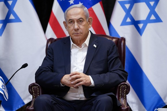 Israeli Prime Minister Benjamin Netanyahu listens as he and President Joe Biden participate in an expanded bilateral meeting with Israeli and U.S. government officials, Wednesday, Oct. 18, 2023, in Te ...