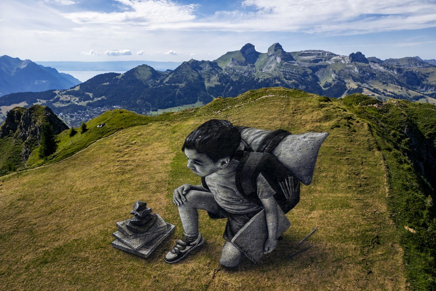A giant biodegradable landart painting entitled &quot;Vers l&#039;horizon&quot; in French, by French-Swiss artist Saype is pictured on the ridges of the Grand Chamossaire mountain, above the alpine re ...