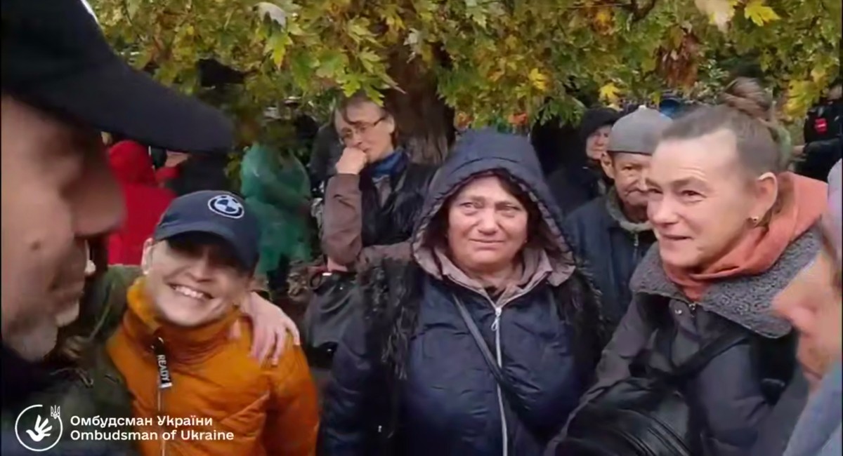 In this screenshot from a video provided by the Office of the Ombudsman of Ukraine, Ukraine's Ombudsman Dmytro Lubinets, left, speaks with residents of Oleshky during their evacuation to a safe a ...