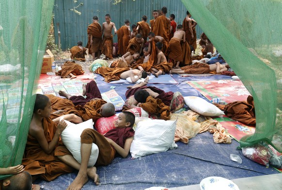 epaselect epa12004420 Young Buddhist novice monks relax at a makeshift temporary shelter in Mandalay, Myanmar, 02 April 2025. More than 2,700 people have been killed and thousands injured after a 7.7- ...
