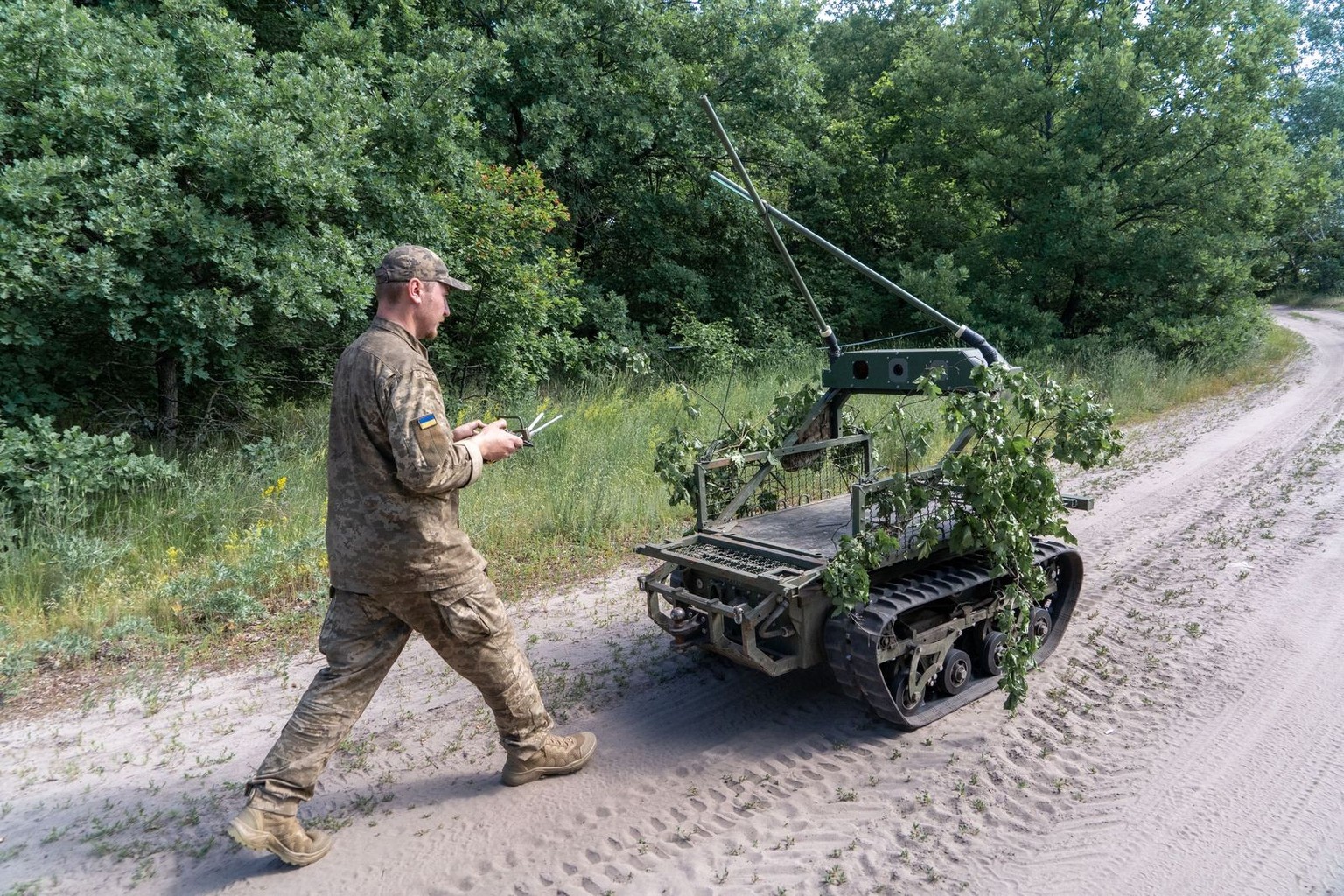A Ukrainian serviceman of the 33rd Mechanized Brigade operates a land combat drone during a training at a polygon in Kharkiv region, Ukraine, Wednesday, June 10, 2026. (AP Photo/Andrii Marienko)