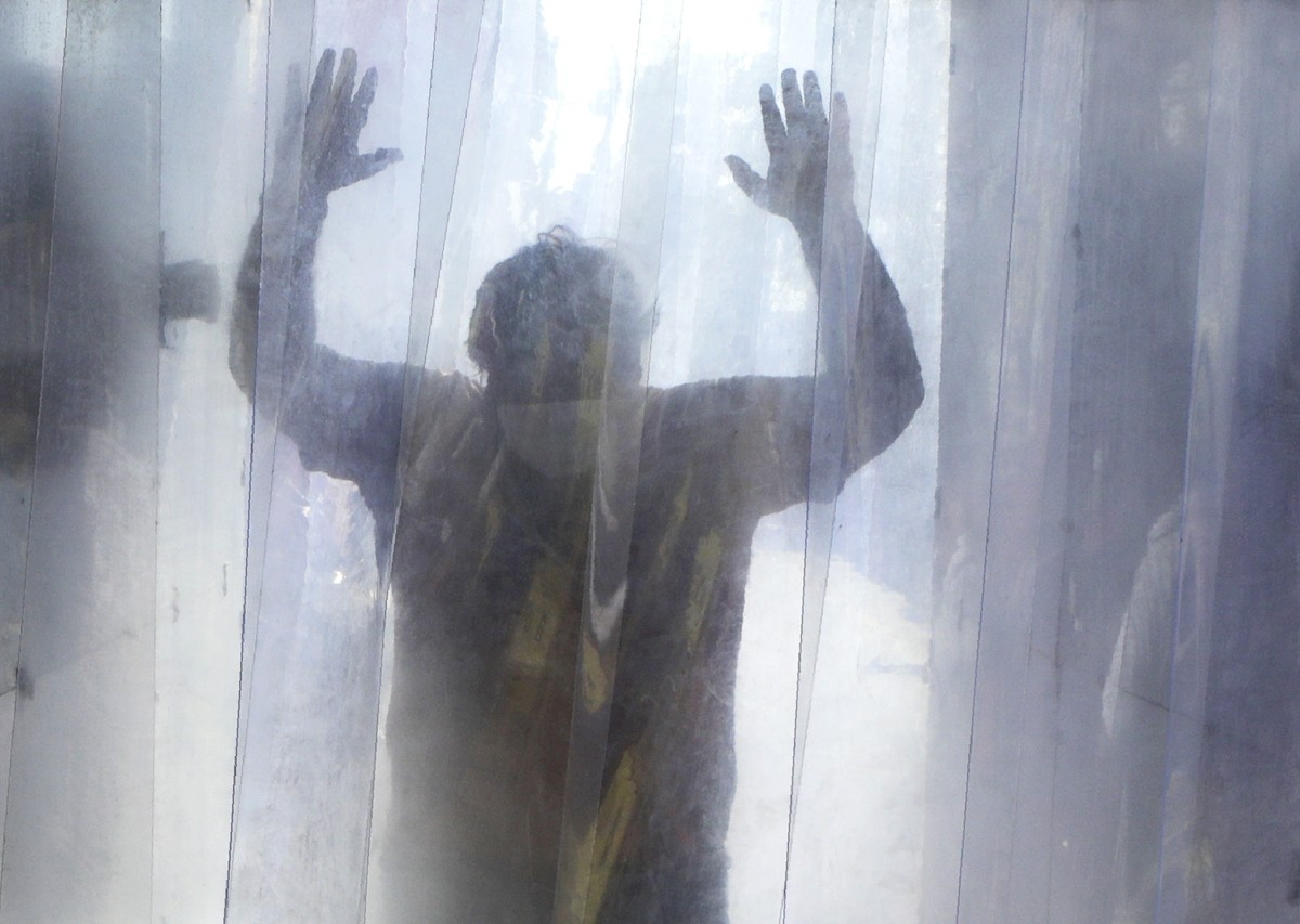 A man gets sanitized in a cabin while leaving a slum in Mumbai, India, Saturday, April 25, 2020. A tentative easing around the world of coronavirus lockdowns gathered pace Saturday with the reopening  ...