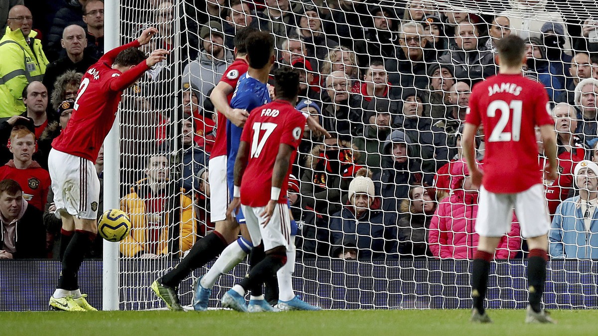Manchester United's Victor Lindelof, left, scores an own goal, giving Everton their first goal of the game during the English Premier League match between Manchester United and Everton at Old Tra ...