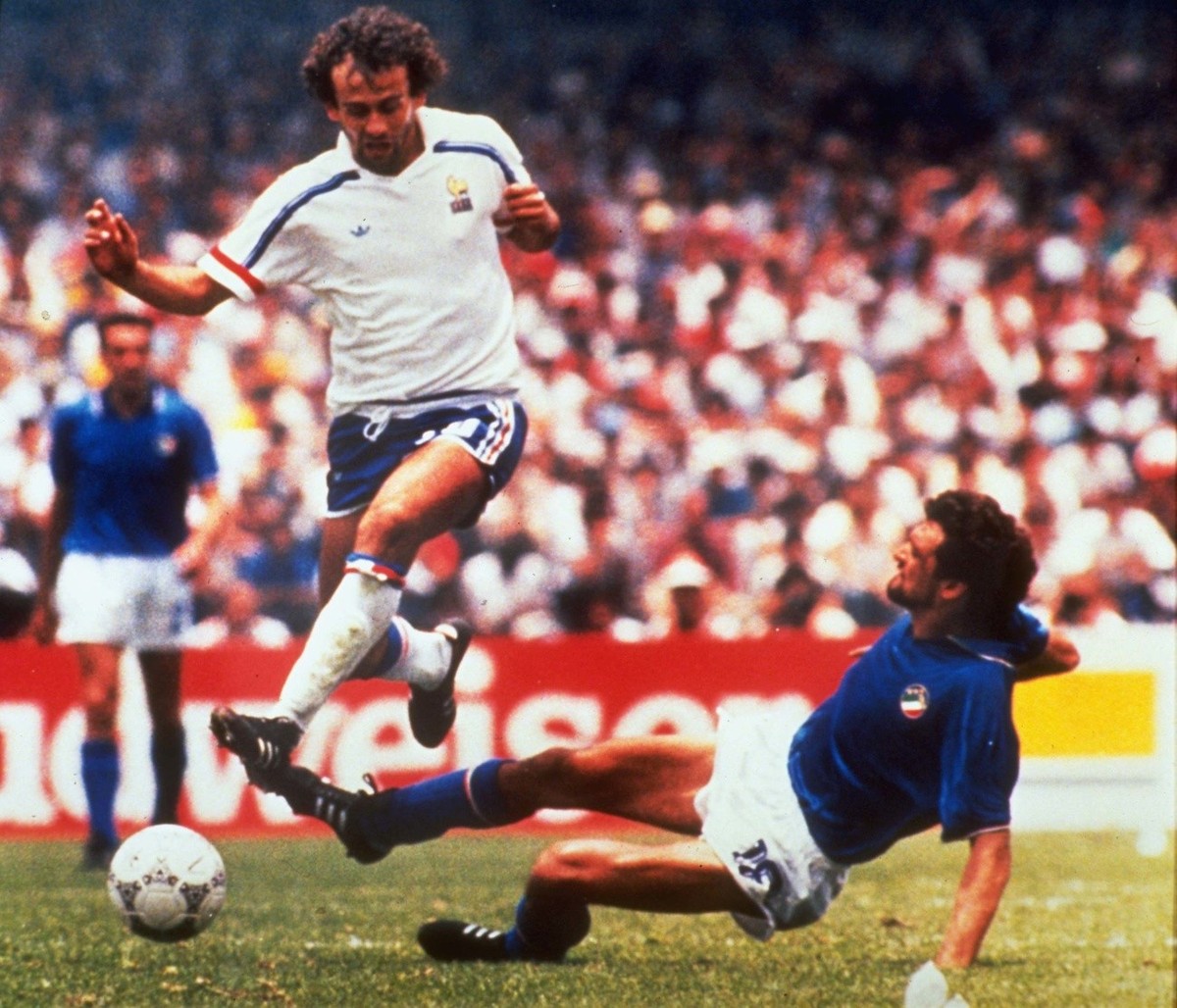 Michel Platini (left) of France dribbles past Italian forward Alessandro Altobelli in their World Cup eight finals in Mexico City's Azteca Stadium on June 17, 1986. France won 2-0 to advance to t ...