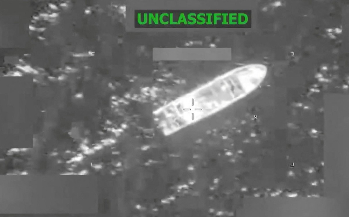 (COMBO) This combination screen grabs from a video posted on the X account of US Southern Command (SOUTHCOM) on February 20, 2026, shows a vessel before (top) and during it being struck at the directi ...