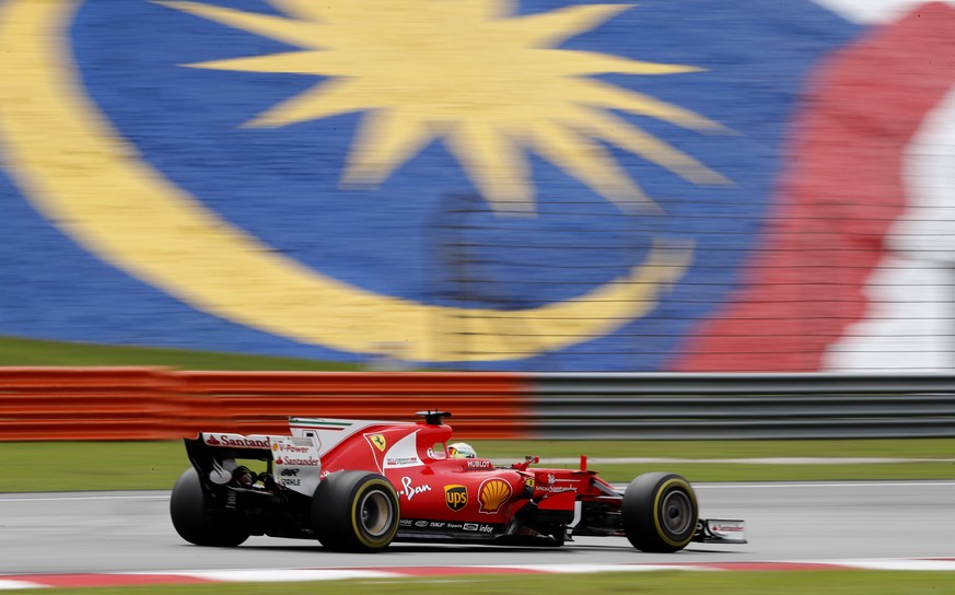 Ferrari driver Sebastian Vettel of Germany steers his car during the Malaysian Formula One Grand Prix at the Sepang International Circuit in Sepang, Malaysia, Sunday, Oct. 1, 2017. (AP Photo/Vincent T ...