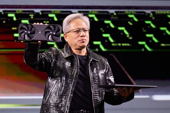 epa11810648 NVIDIA founder and CEO Jensen Huang holds up the new RTX Blackwell and RTX 5070 laptop during the NVIDIA keynote at the 2025 Consumer Electronics Show being held at the Mandalay Bay hotel  ...