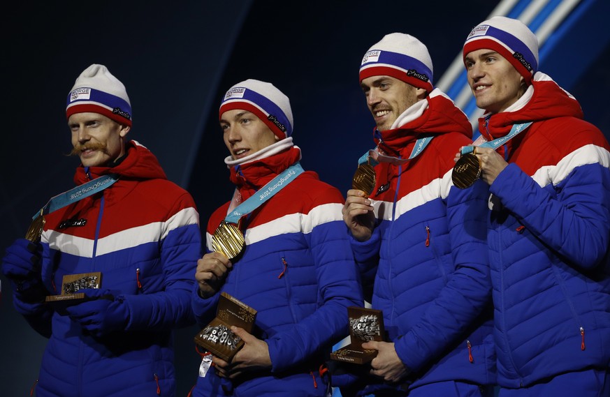 Ski jumping team gold medalists from Norway celebrate during their medals ceremony at the 2018 Winter Olympics in Pyeongchang, South Korea, Tuesday, Feb. 20, 2018. (AP Photo/Charlie Riedel)