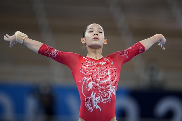 Tang Xijing, of China, finishes on the balance beam during the artistic gymnastics women&#039;s apparatus final at the 2020 Summer Olympics, Tuesday, Aug. 3, 2021, in Tokyo, Japan. (AP Photo/Natacha P ...
