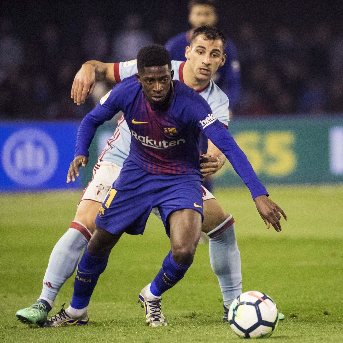 Barcelona's Ousmane Dembele, foreground, challenges for the ball with RC Celta's Jonny Otto during a Spanish La Liga soccer match between RC Celta and Barcelona at the Balaidos stadium in Vi ...