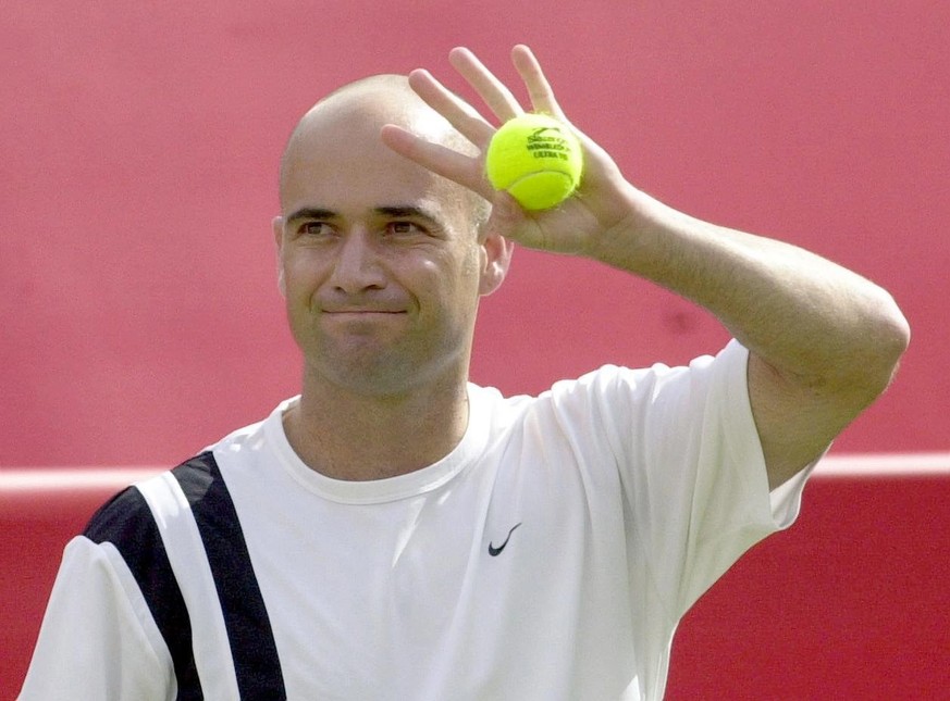 American Andre Agassi waves to the crowd before his 1000th career match against Australia&#039;s Peter Luczak at the Stella Artois Championships at Queen&#039;s Club, London, on Tuesday, 10 June 2003. ...