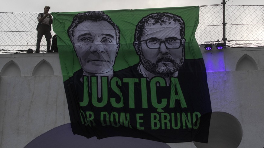 FILE - A sign that reads in Portuguese &quot;Justice for Dom and Bruno&quot; and with images of the British journalist Dom Phillips, on the left, and the indigenous specialist Bruno Pereira is display ...