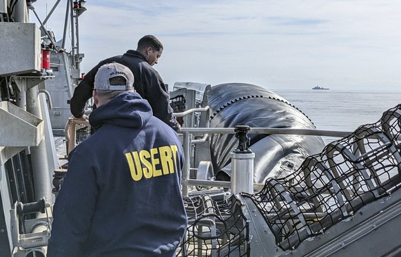 In this image provided by the FBI, FBI underwater search evidence response team members prepare equipment as they work to recover material on the ocean floor from the high altitude balloon that was sh ...