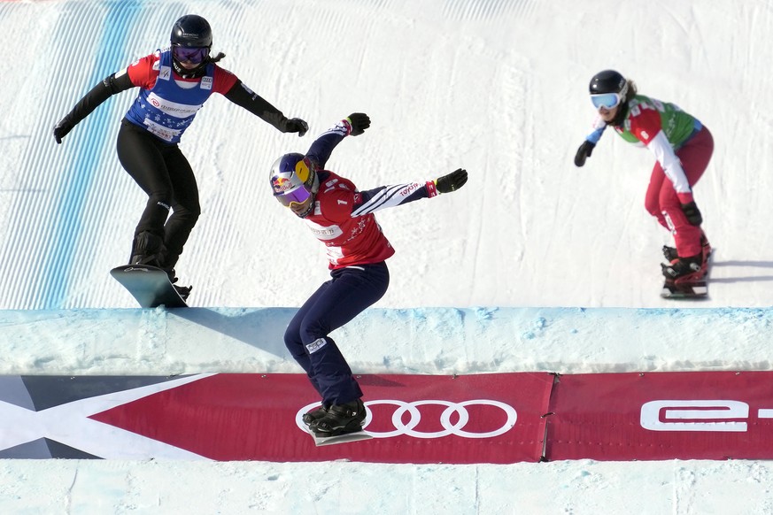 From left, Belle Brockhoff of Australia, Eva Samkova of the Czech Republic, and Sina Siegenthaler of Switzerland compete during a quarterfinal of women&#039;s snowboard cross at the FIS Snowboard Cros ...