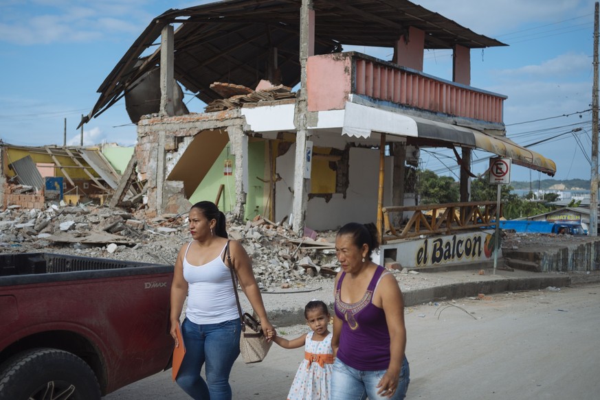 On 5 May 2016, two women and a young girl walk past a building destroyed by the earthquake in Nuevo Pedernales, Manabi, Ecuador.

As at 30 April 2016, it is estimated that approximately 720,000 of the ...