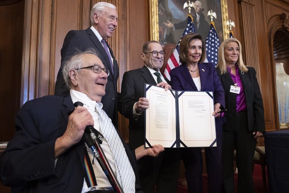 epa10355649 US Speaker of the House Nancy Pelosi (2-R) poses with the bill beside the first openly gay member of Congress, former Democratic Representative of Massachusetts Barney Frank (L); House Maj ...