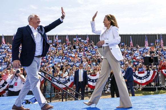 Democratic presidential nominee Vice President Kamala Harris is welcomed by running mate Democratic vice presidential nominee Minnesota Gov. Tim Walz before she delivers remarks at a campaign rally in ...