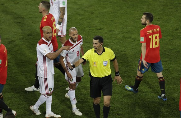 Morocco&#039;s Karim El Ahmadi (8) talks to referee Ravshan Irmatov from Uzbekistan after the group B match between Spain and Morocco at the 2018 soccer World Cup in the Kaliningrad Stadium in Kalinin ...